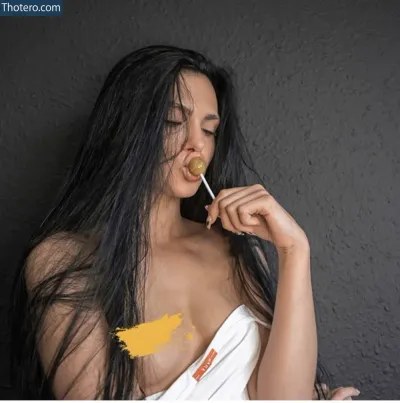 Diana Black - woman with long black hair eating a banana