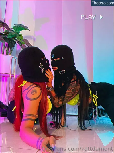 DElettraa - there are two women in black masks and one is wearing a pink outfit