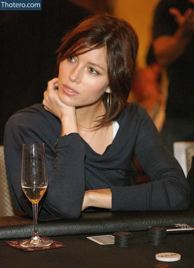 Jessica Biel - woman sitting at a table with a glass of wine