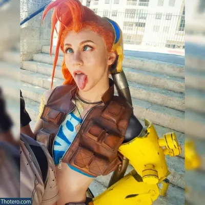 Michal Cosplay - there is a woman with a red hair and a brown vest
