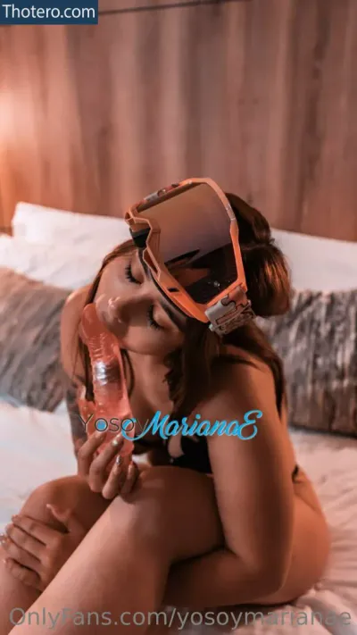 Mariana Echeverri - a close up of a woman in a bikini sitting on a bed