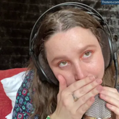 Kelly Belly ASMR - woman with headphones on biting into a piece of bread