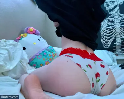Lexie Wilson - in a diaper laying on a bed next to a stuffed animal