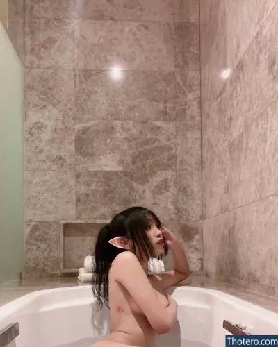 leezipotato - there is a woman sitting in a bathtub with a towel on her head