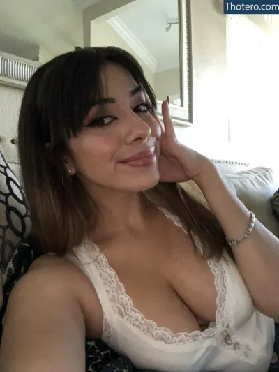 superskank - woman in a white tank top sitting on a couch