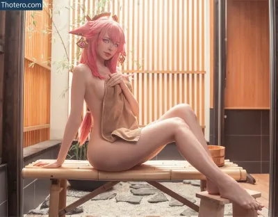 Peachmilky_ - there is a woman with pink hair sitting on a bench