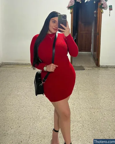 lamartinezruiz - woman in a red dress taking a selfie in a mirror