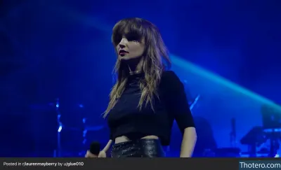 Lauren Mayberry - woman in black top and leather skirt on stage