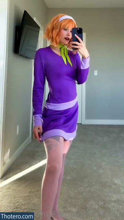 Catziilla - in a purple dress taking a selfie in a room