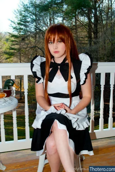 Foxy Cosplay - woman in a maid outfit sitting on a porch