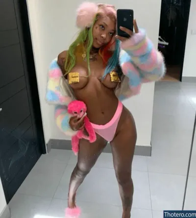 Summer Walker - with colorful hair and a pink teddy bear taking a selfie