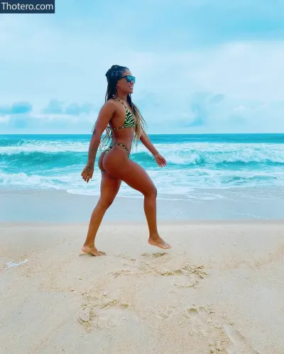 Marvvila - woman in a bikini walking on the beach