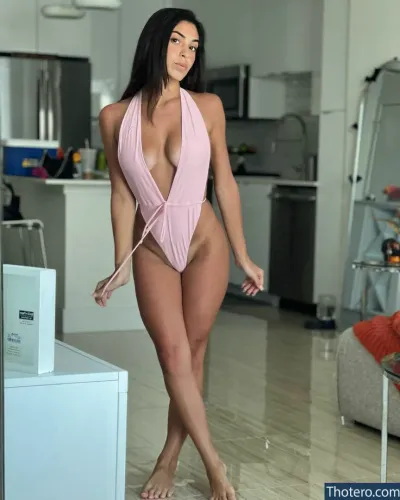 Mirandamarie - woman in a pink swimsuit standing in a kitchen