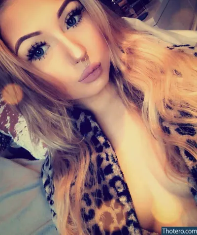 Holly Jo Ballard - woman with long blonde hair and a leopard print shirt