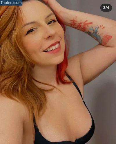 Ammyzitta - there is a woman with red hair and a tattoo on her arm