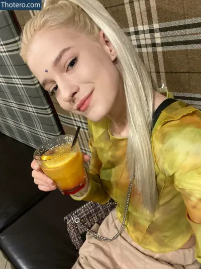 Angela_devil666 - blond woman with long blond hair holding a glass of orange juice