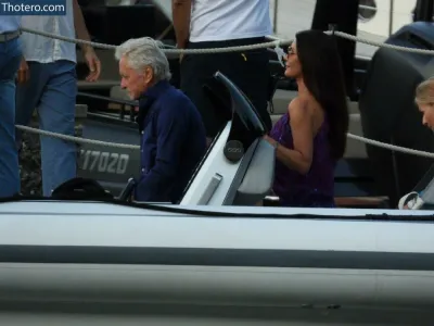 Catherine Zeta-Jones - man and woman in a boat with a man in a blue shirt