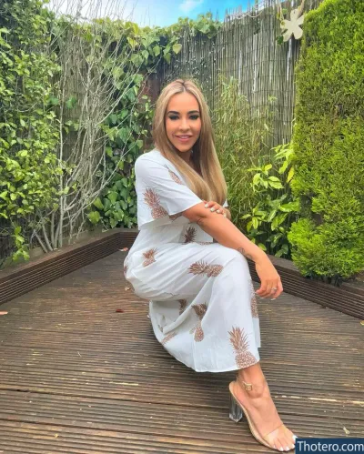 Hollyoaks - a woman sitting on a wooden deck in a white dress