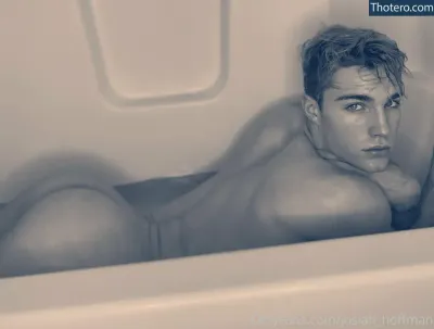 hazel_hoffman - man laying in a bathtub with his shirt off