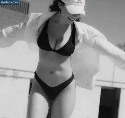 Sasha_Emeri - woman in a bikini and hat is standing on a skateboard