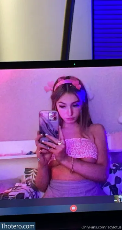 lacylotus - woman in a pink top is looking at her cell phone