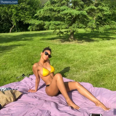 marieanna16 - woman in a bikini laying on a blanket in a park