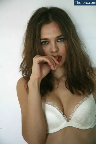 Nina Kraviz - a close up of a woman in a white bra top posing for a picture
