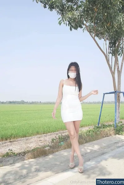 rin-run_outdoor - woman in a white dress and mask walking down a sidewalk