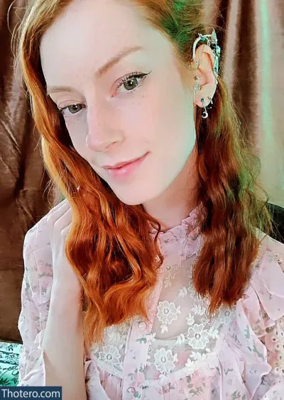 MissChloeASMR - a close up of a woman with red hair wearing a pink dress