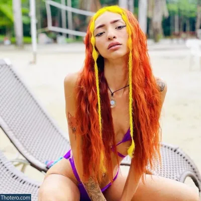 Ruivinha De Marte - woman with orange hair sitting on a beach chair