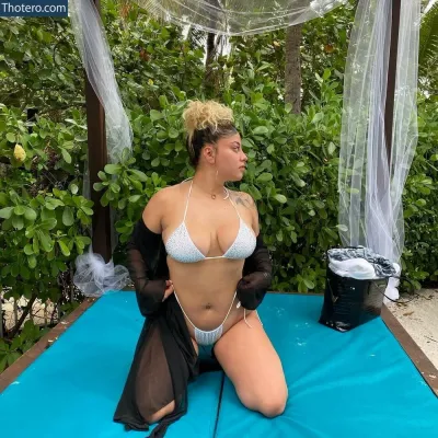 Domovelez - there is a woman in a bikini sitting on a blue mat