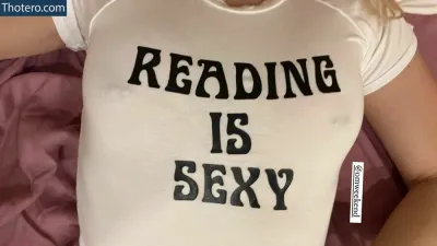 Willow Shields - woman laying on a bed with a reading is sexy shirt