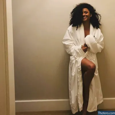 Rhyon Nicole Brown - woman in a robe sitting on a toilet in a bathroom