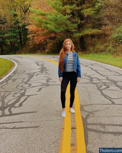 Samantha - woman standing on a road with a yellow line