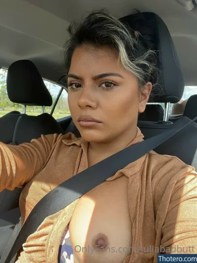 JuliaBadButt - woman in a car with a tan shirt and a tan sweater