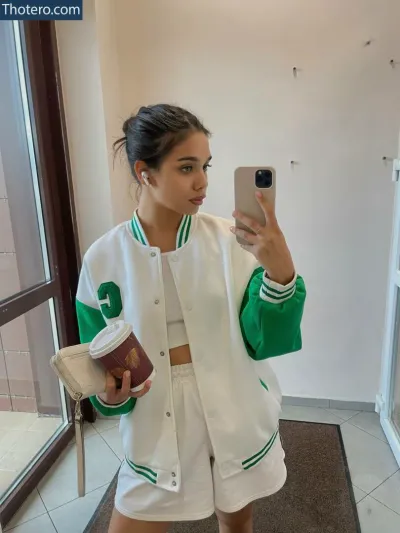 Emily Angel - woman taking a selfie in a white and green jacket