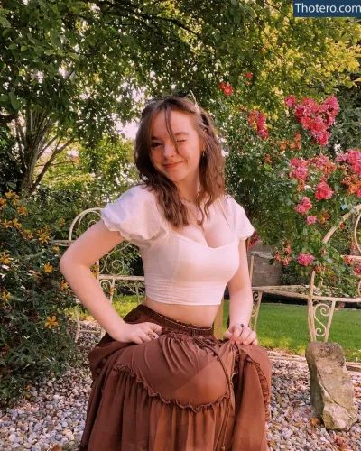 Laura Anne - woman in a skirt posing for a picture in a garden