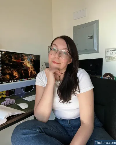 Swell Entertainment - woman sitting in front of a computer desk with a monitor and keyboard