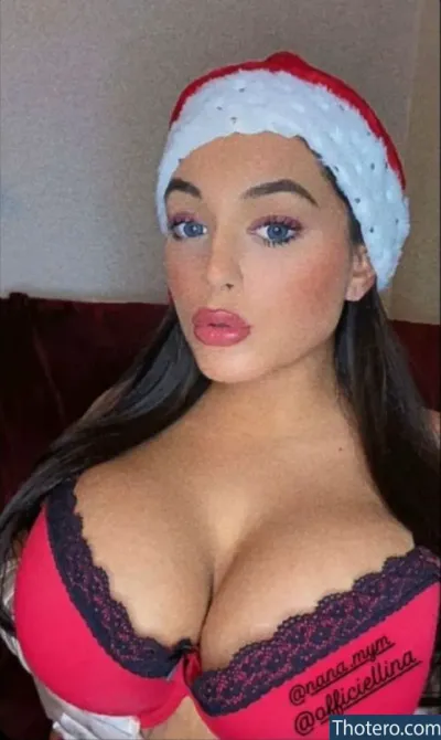 Nana_off - a close up of a woman wearing a santa hat and bra