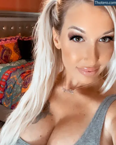 Lacey Denae - a close up of a woman with long blonde hair and a gray tank top
