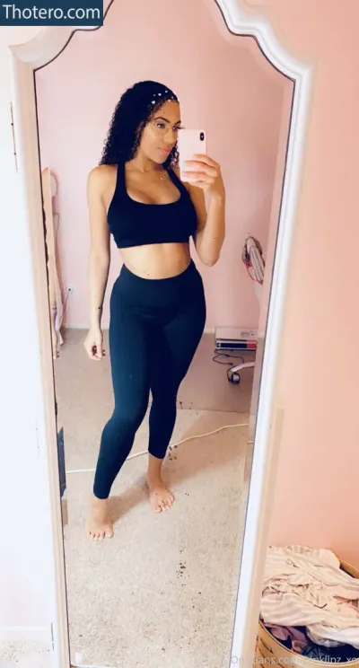 pinklipz_xo - a woman taking a selfie in a mirror in a room