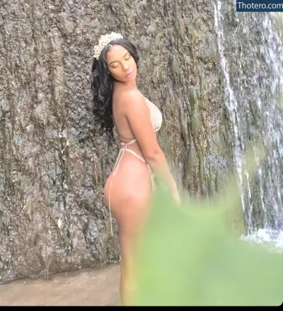 Tyaisha Neblett - woman in a bikini standing in front of a waterfall