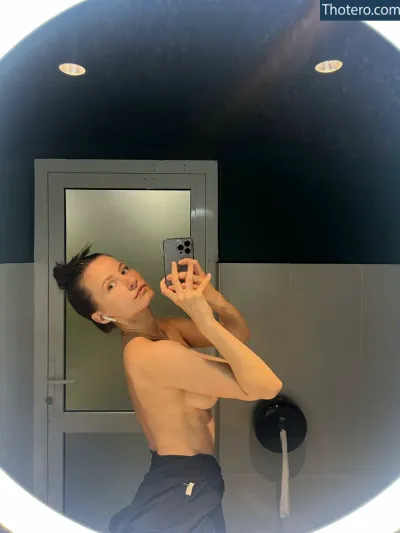 Toma Efremova - man taking a selfie in a mirror in a bathroom