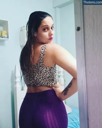 Christine Rayssa - woman in a leopard print top and purple skirt