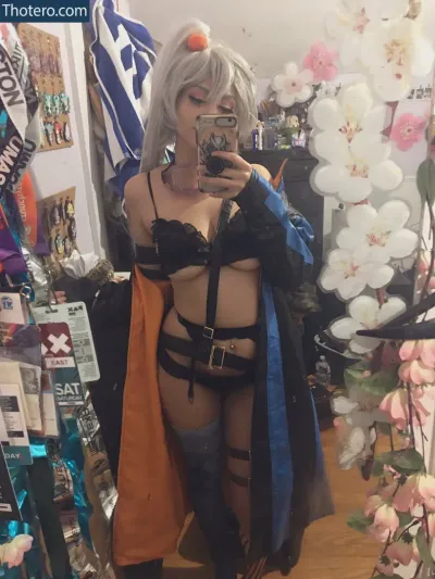 Plushiecos - woman in a black outfit taking a selfie in a store