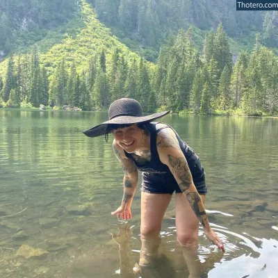 Holly Conrad - woman in a black hat and a black swim suit in a lake