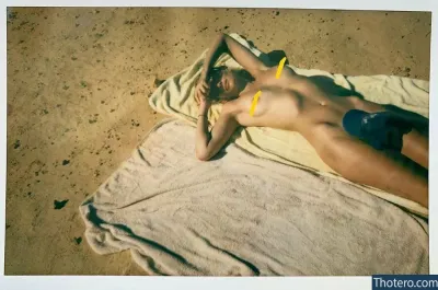 Marloes Horst - there is a man laying on a towel on the beach