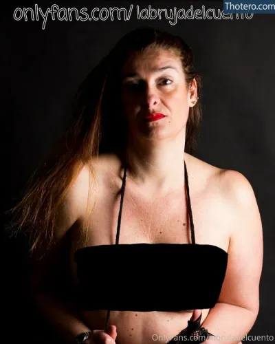 labrujadelcuento - there is a woman with a black top and a red lipstick