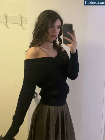 Skatie420 - woman taking a selfie in a mirror in a black top
