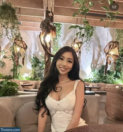 Supcaitlin - woman sitting on a couch in a white dress